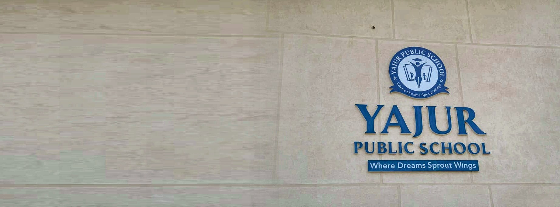 The Yajur Public School crest and sign on the Hunter Road campus