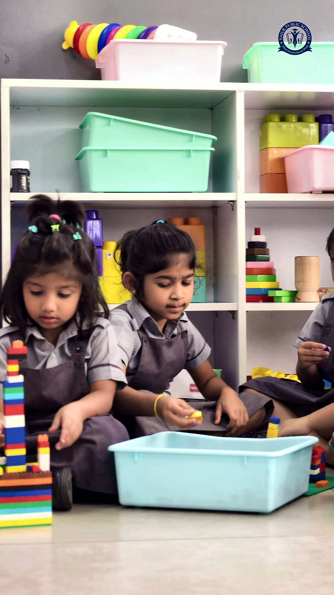 Two pre-primary girls building with blocks