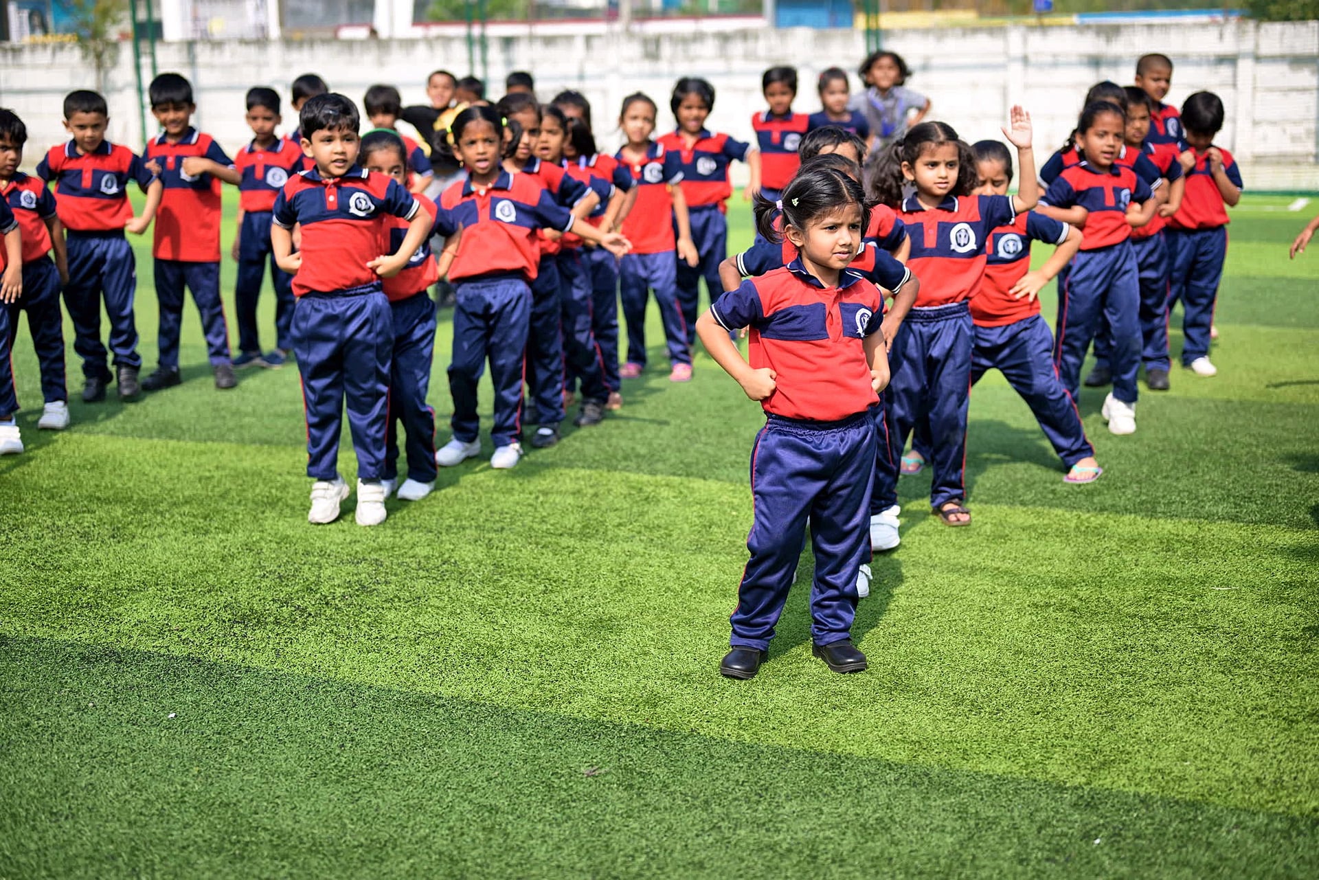 Young Yajur students in a PE session on the turf